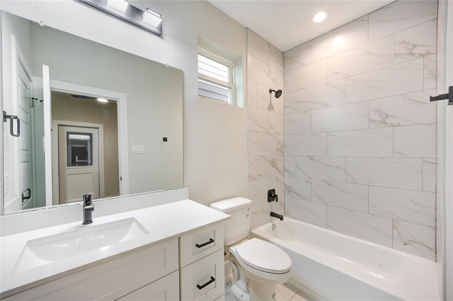 En-suite Bathroom with quartz countertops and storage drawers