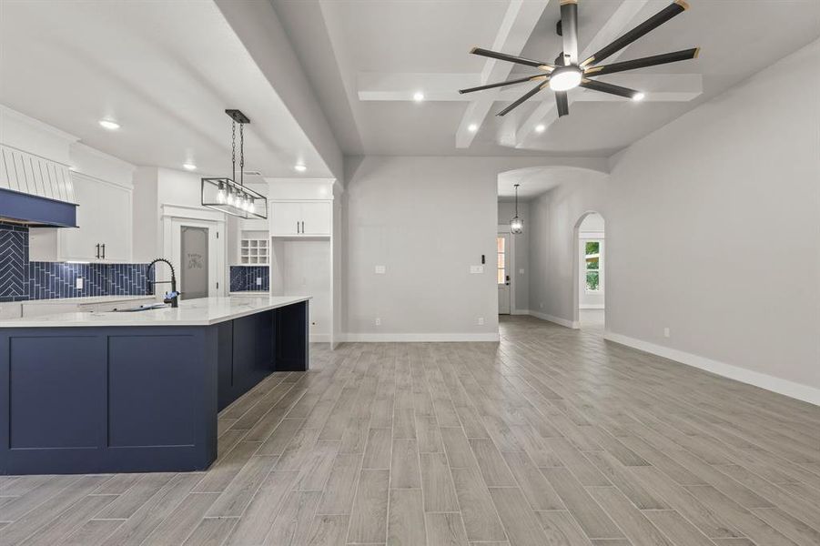 Kitchen with recessed lighting, ceiling fan, a sink, light countertops, and white cabinetry
