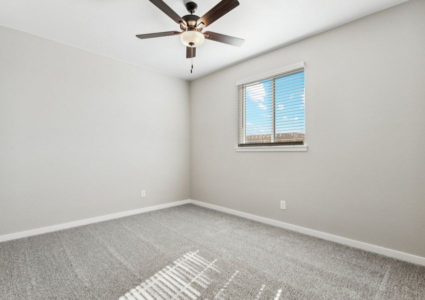The master bedroom is spacious with a ceiling fan.