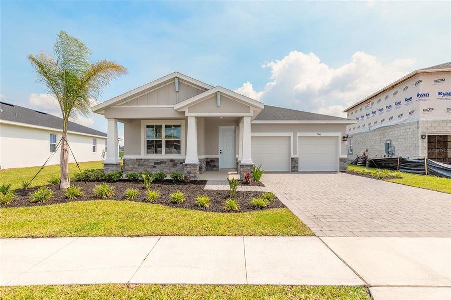 Front exterior of a new home in The Palms at Venetian Bay, New Smyrna Beach, FL, highlighting curb appeal (Image 2). Front exterior of a new home in The Palms at Venetian Bay, New Smyrna Beach, FL, highlighting curb appeal (Image 2).