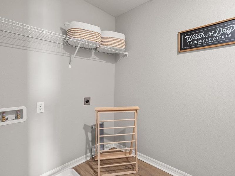 A dedicated laundry room is conveniently located upstairs, near the bedrooms - Isla townhome by Highland Homes