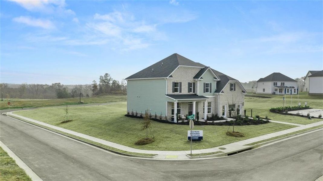 Front exterior of a new home in Evergreen Crossing, Locust Grove, GA, highlighting curb appeal (Image 2). Front exterior of a new home in Evergreen Crossing, Locust Grove, GA, highlighting curb appeal (Image 2).