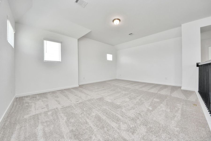 Come upstairs and enjoy a day of leisure in this fabulous game room! This is the perfect hangout spot or adult game room! Features plush carpet, high ceilings, custom paint and windows for plenty of natural light. Come upstairs and enjoy a day of leisure in this fabulous game room! This is the perfect hangout spot or adult game room! Features plush carpet, high ceilings, custom paint and windows for plenty of natural light.