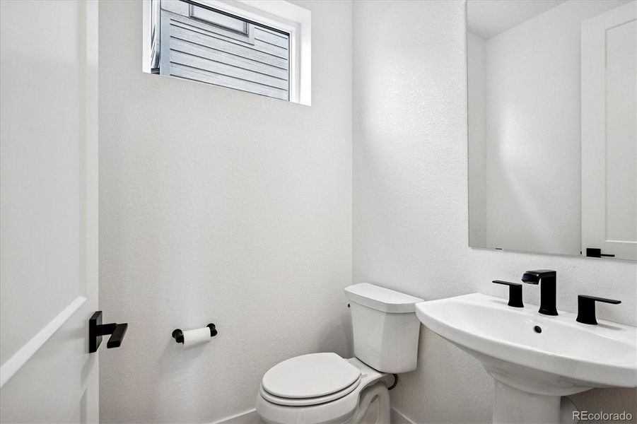 Powder room for main level and guest use Powder room for main level and guest use