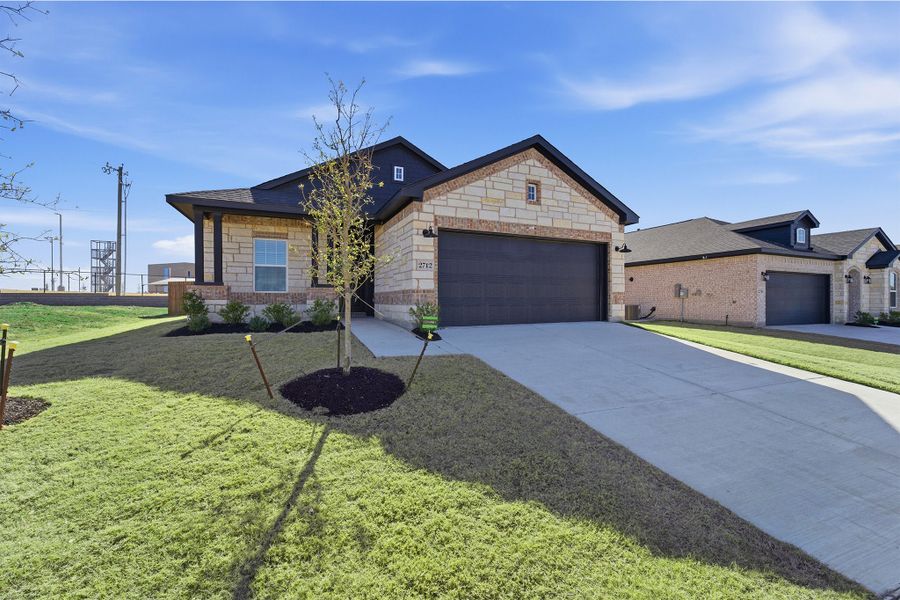 Front exterior of a new home in Pebblebrook, Sherman, TX, highlighting curb appeal (Image 2).
