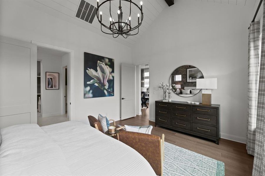 Bedroom featuring hanging lights, dark wood-style floors, and lofted ceiling Bedroom featuring hanging lights, dark wood-style floors, and lofted ceiling