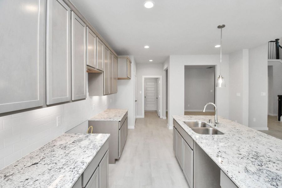 This generously spacious kitchen is a dream realized! Sample photo of completed home with similar floor plan. Actual colors and selections may vary. This generously spacious kitchen is a dream realized! Sample photo of completed home with similar floor plan. Actual colors and selections may vary.