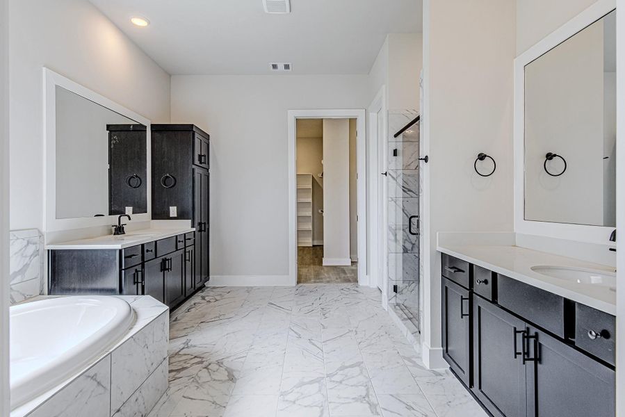 Luxurious primary bath with dual vanities and soaking tub Luxurious primary bath with dual vanities and soaking tub