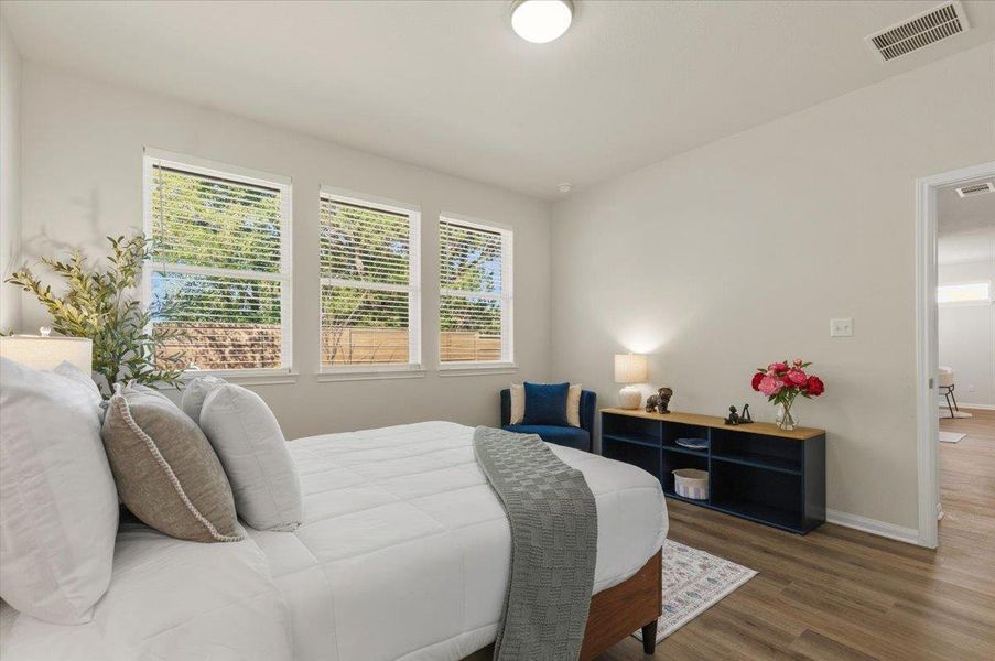 Three windows line the rear wall for natural light and back yard views.