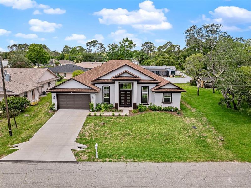 Front exterior of a new home in , Palm Coast, FL, highlighting curb appeal (Image 2). Front exterior of a new home in , Palm Coast, FL, highlighting curb appeal (Image 2).