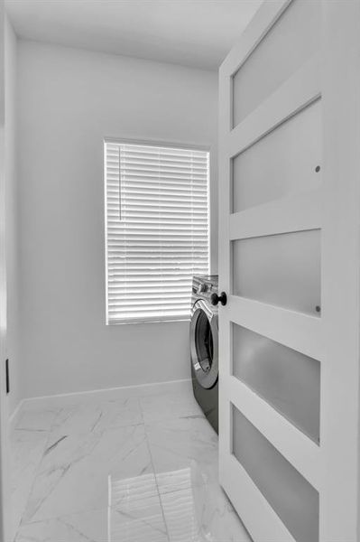 Washroom with light marble finish flooring and baseboards Washroom with light marble finish flooring and baseboards