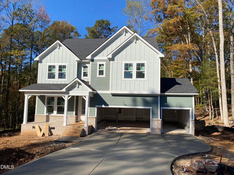 Front exterior of a new home in Laneridge Estates, Raleigh, NC, highlighting curb appeal (Image 1).