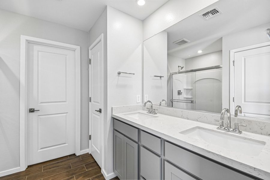 A bathroom with white cabinets. A bathroom with white cabinets.