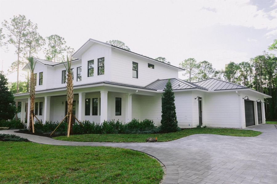 Front exterior of a new home in , Jupiter, FL, highlighting curb appeal (Image 1).