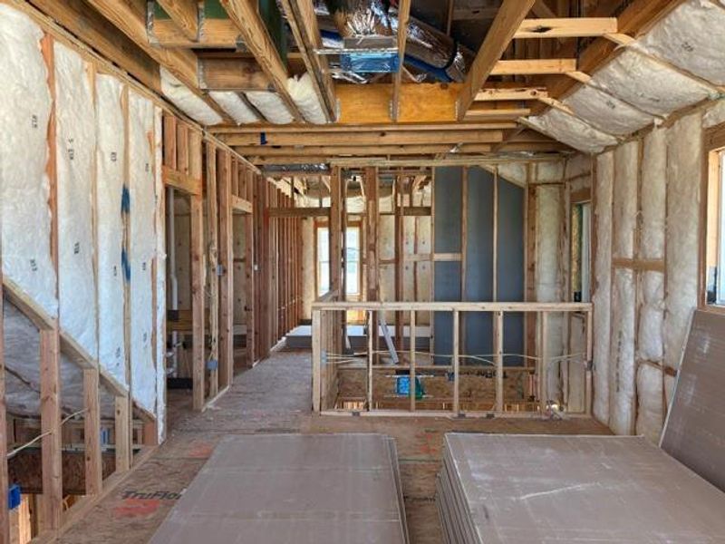 Framing and insulation define the emerging spaces within this home under construction.