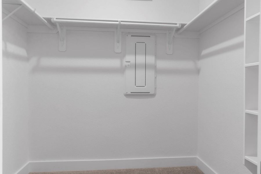Expansive walk-in closet with built-in shelving and hanging space to keep your wardrobe organized. Expansive walk-in closet with built-in shelving and hanging space to keep your wardrobe organized.
