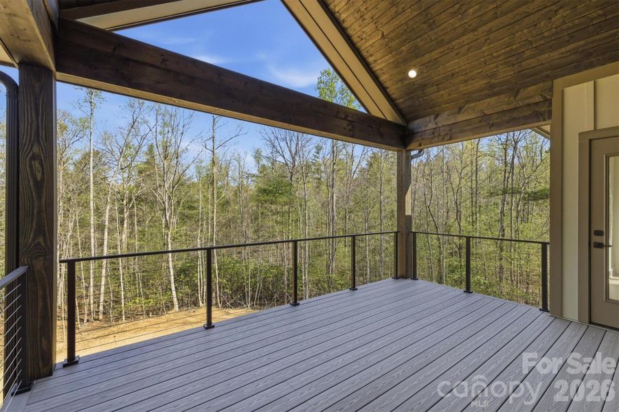Once on the deck, the views will capture your attention, but the cathedral ceiling and the open triangle on the end of the house accentuate the experience. There is also recessed lighting and horizontal railings. The flooring is Armadillo Composite Decking and is both durable and low-maintenance. This would be a very relaxing spot for morning coffee and evening wine! Once on the deck, the views will capture your attention, but the cathedral ceiling and the open triangle on the end of the house accentuate the experience. There is also recessed lighting and horizontal railings. The flooring is Armadillo Composite Decking and is both durable and low-maintenance. This would be a very relaxing spot for morning coffee and evening wine!