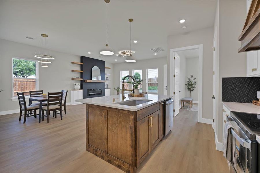 Kitchen with a sink, stainless steel appliances, plenty of natural light, light countertops, and recessed lighting Kitchen with a sink, stainless steel appliances, plenty of natural light, light countertops, and recessed lighting