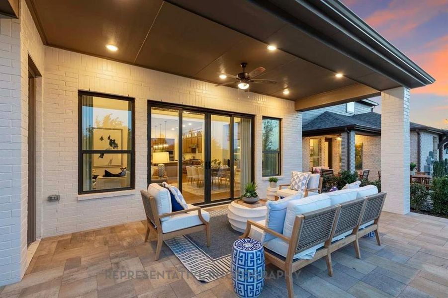 Patio terrace at dusk featuring a ceiling fan, a patio area, and an outdoor living space Patio terrace at dusk featuring a ceiling fan, a patio area, and an outdoor living space