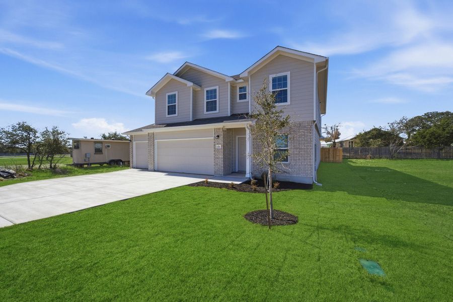 Front exterior of a new home in Grande Estates, Bertram, TX, highlighting curb appeal (Image 2).