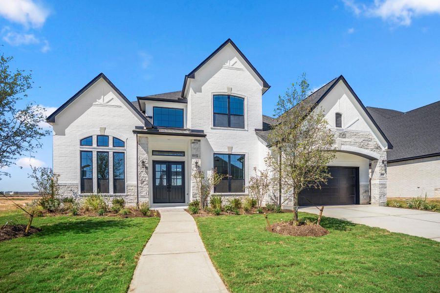 Front exterior of a new home in Jordan Ranch 70' Lots, Fulshear, TX, highlighting curb appeal (Image 2).