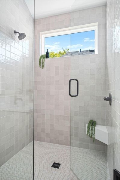 Bathroom featuring a shower stall and healthy amount of natural light Bathroom featuring a shower stall and healthy amount of natural light