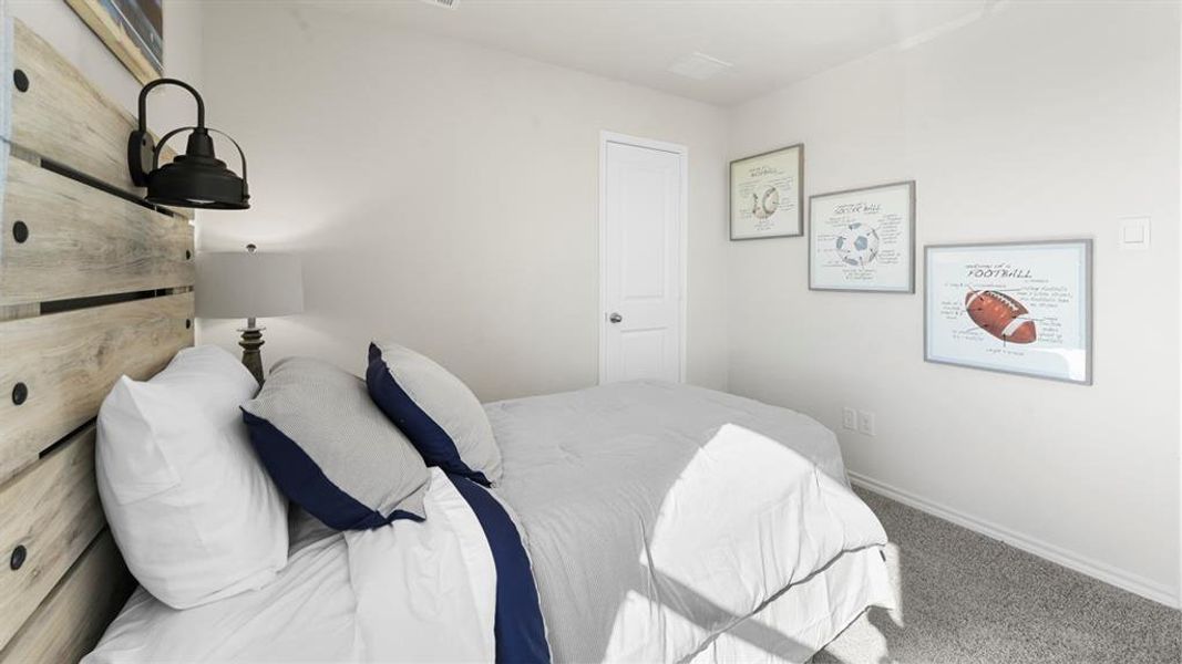 Carpeted bedroom with baseboards