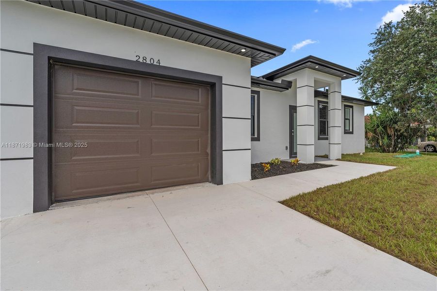 Front exterior of a new home in , Lehigh Acres, FL, highlighting curb appeal (Image 16).