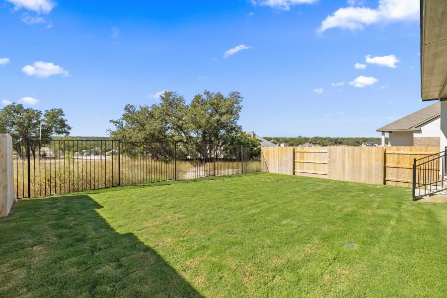 Exterior details and patio area of a home in Lariat, Liberty Hill (Image 28).
