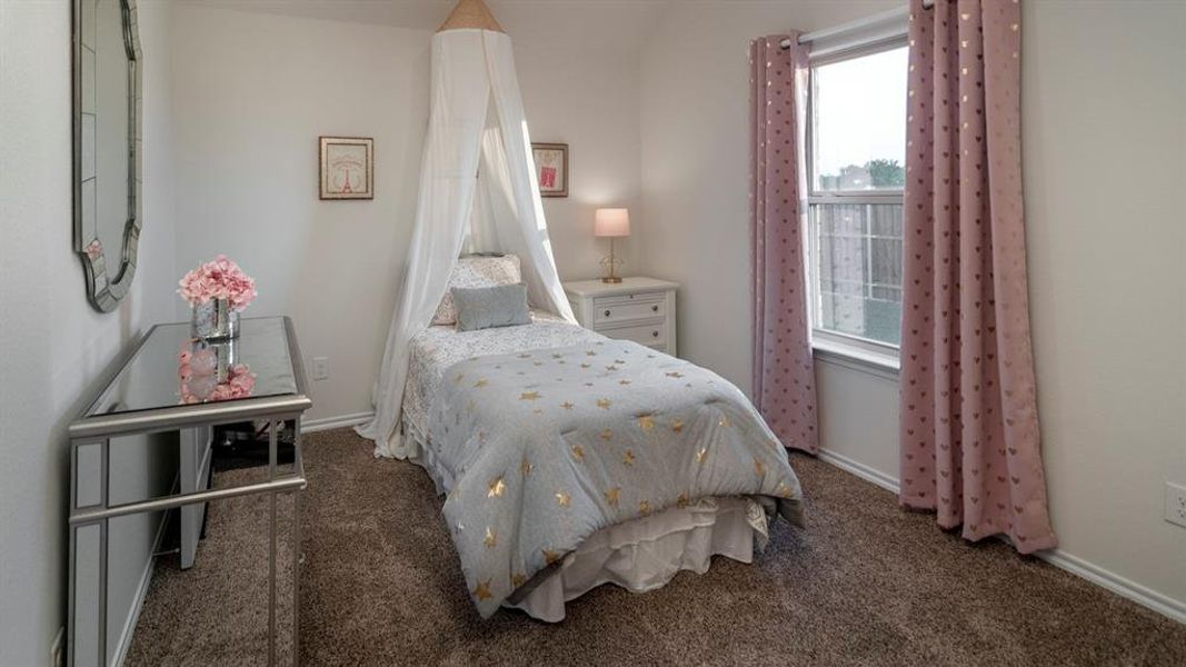Bedroom featuring baseboards and dark colored carpet
