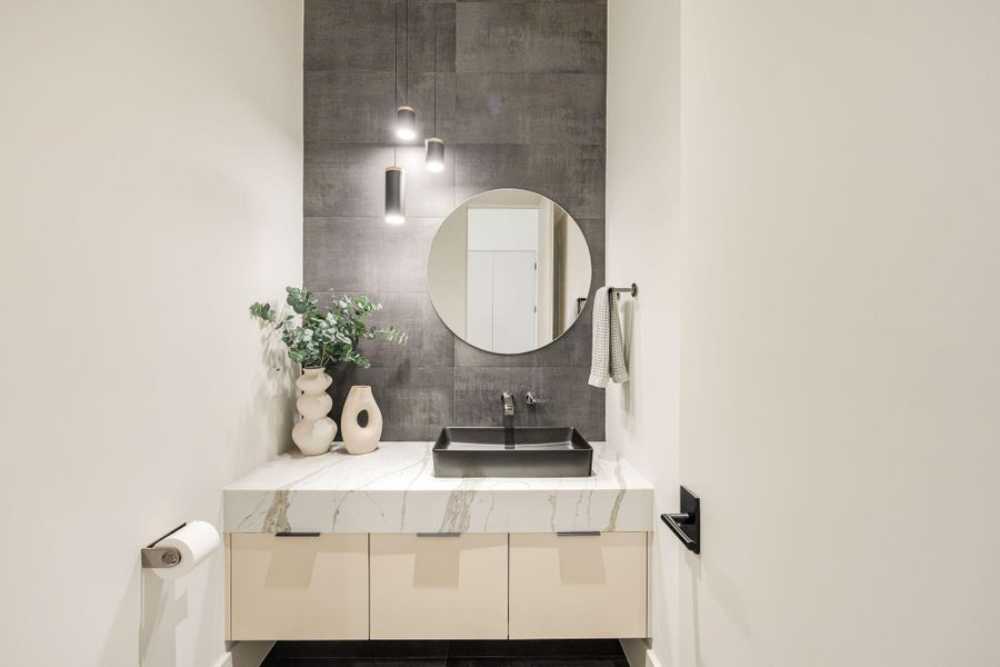 [POWDER RM-1ST FLR] A chic first-floor powder room impresses with curated designer finishes and timeless elegance, offering both style and functionality.