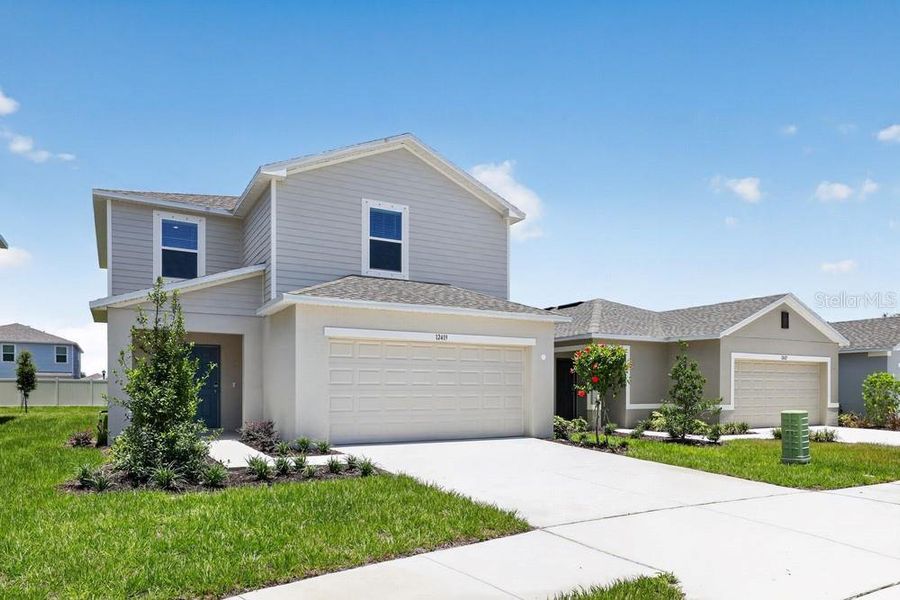 Front exterior of a new home in Palm Wind, Hudson, FL, highlighting curb appeal (Image 24).