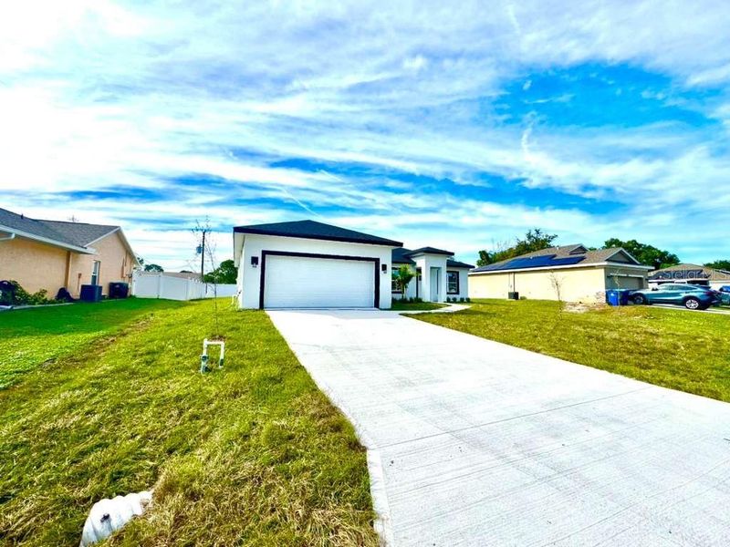 Front exterior of a new home in , Palm Bay, FL, highlighting curb appeal (Image 2).