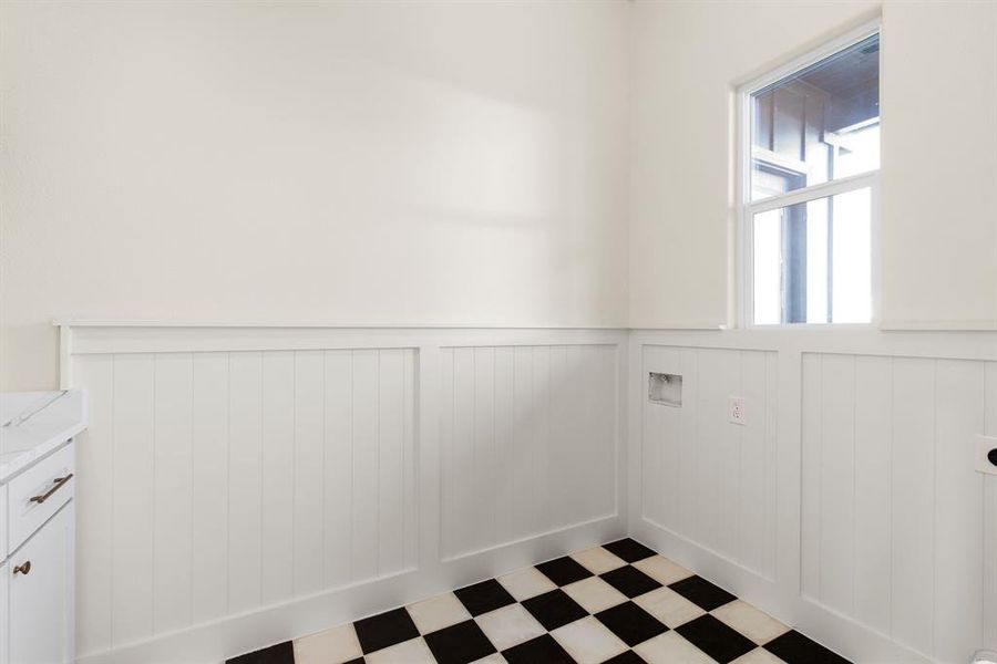 Washroom with hookup for an electric dryer, cabinets, and washer hookup