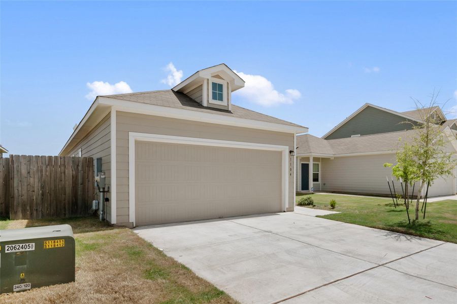 View of front of home featuring an attached garage and driveway View of front of home featuring an attached garage and driveway