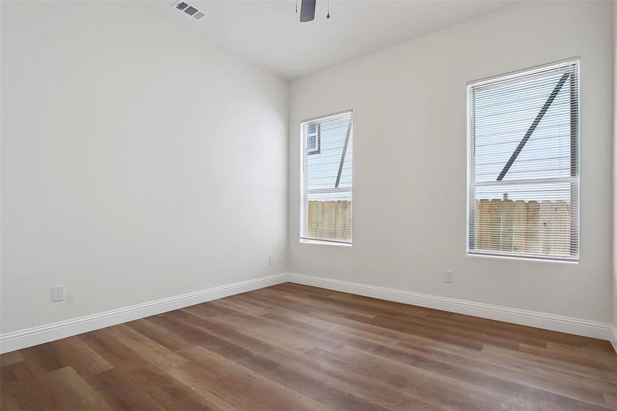 Empty room featuring hardwood / wood-style flooring and ceiling fan