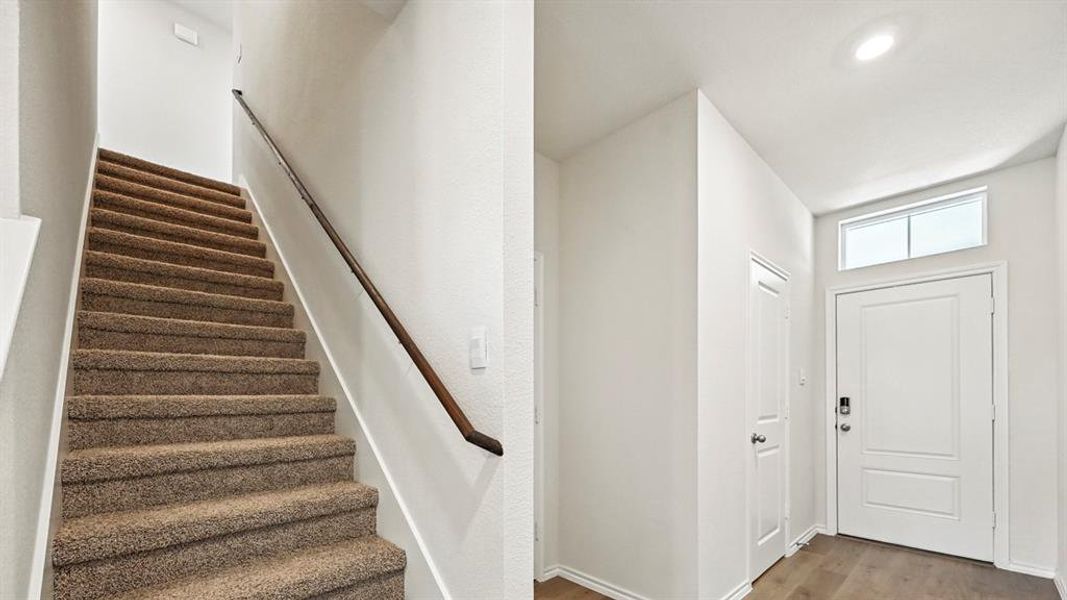 Foyer featuring wood finished floors and stairway