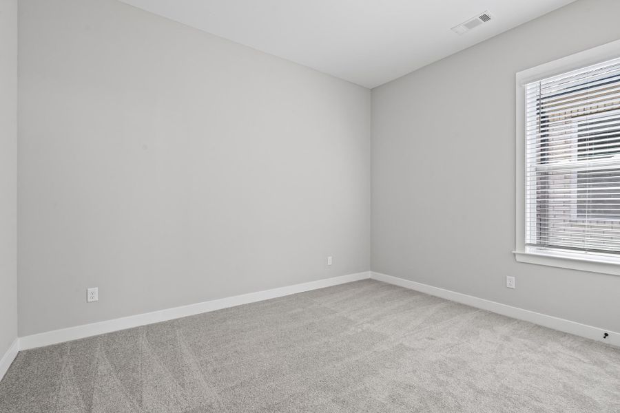 Unfurnished room featuring light carpet