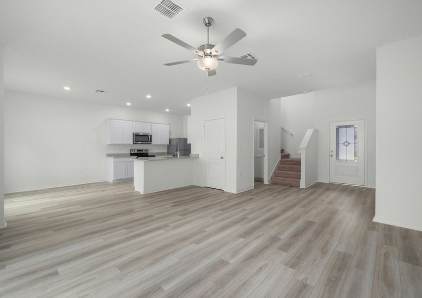 The spacious open-concept first floor with vinyl flooring