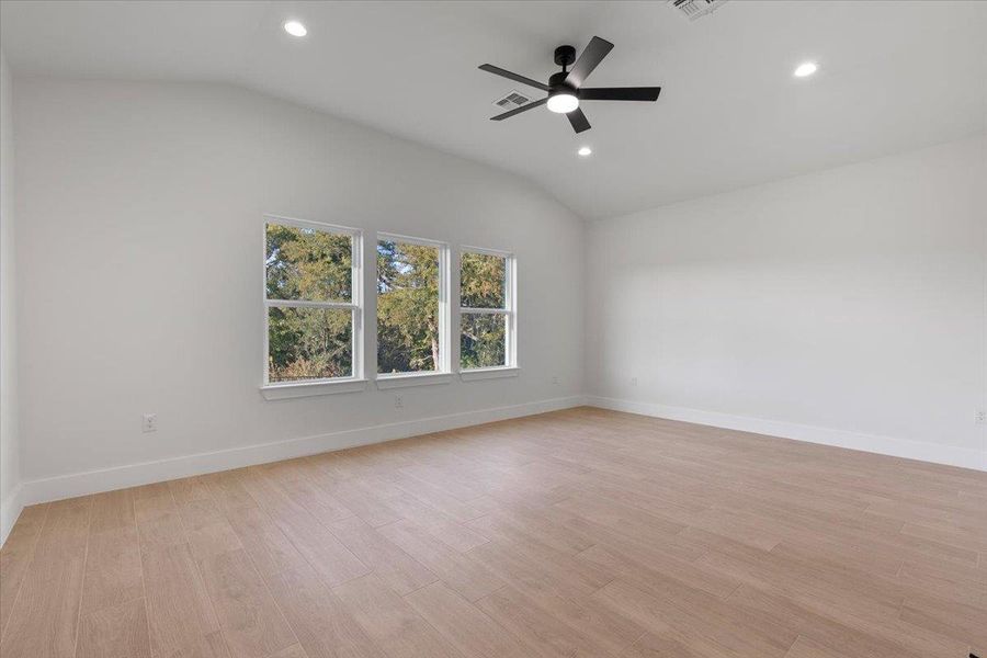 Unfurnished room featuring vaulted ceiling, light wood-style flooring, recessed lighting, and ceiling fan Unfurnished room featuring vaulted ceiling, light wood-style flooring, recessed lighting, and ceiling fan