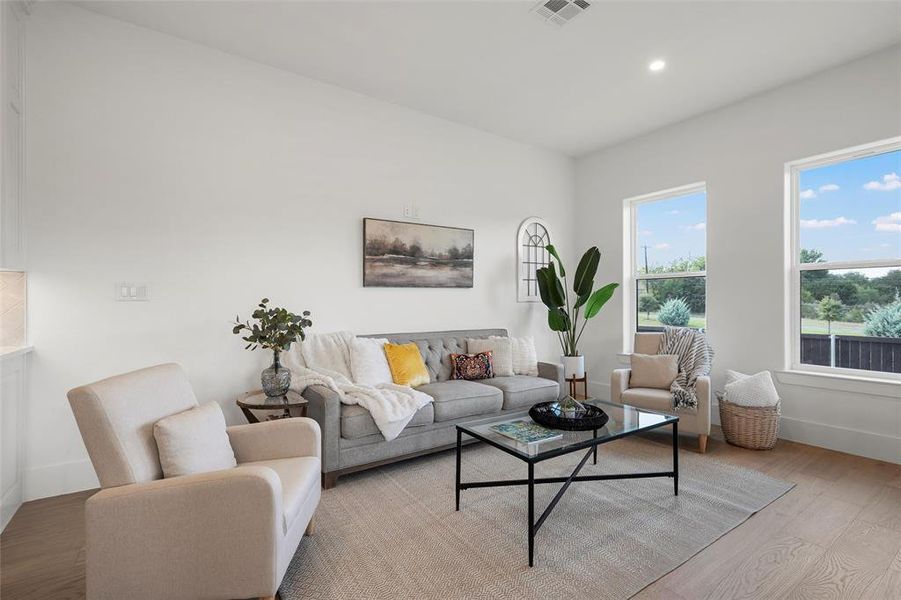 Living area with wood finished floors and recessed lighting Living area with wood finished floors and recessed lighting