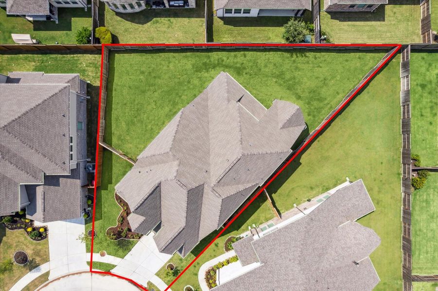 Aerial shot showcasing both the home and the extensive outdoor space for recreation and entertaining.