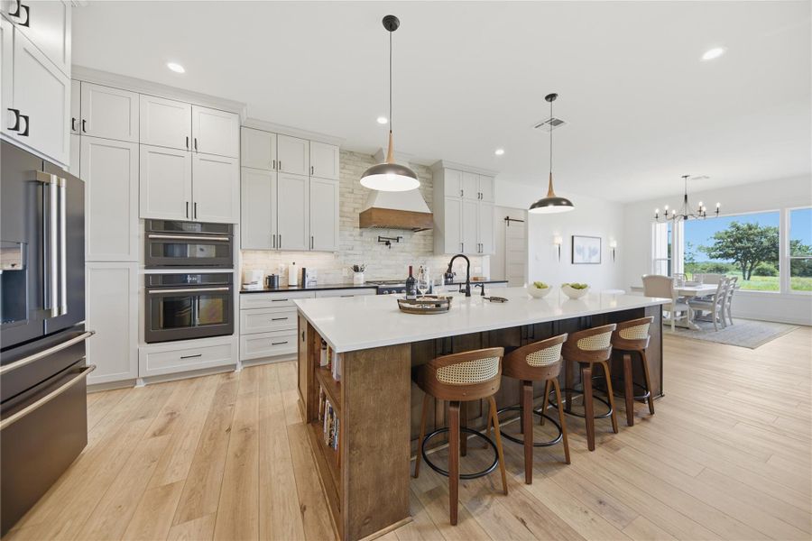 Culinary aspirations meet sophisticated design in this luminous kitchen, showcasing a spacious island and modern finishes.