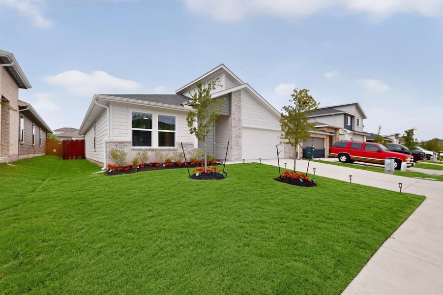 A neatly manicured lawn enhances the curb appeal of this contemporary suburban home.