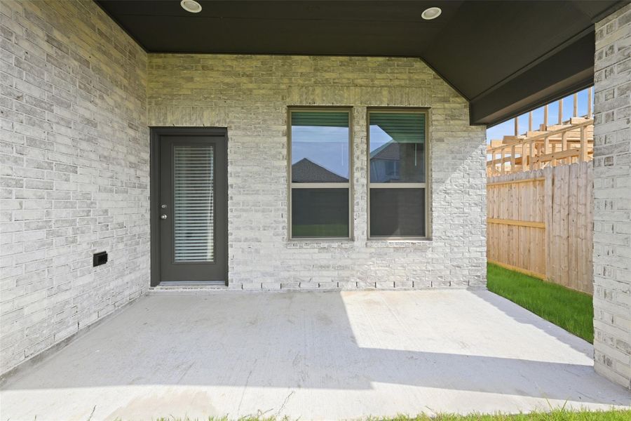 Charming covered patio with sleek brickwork, perfect for outdoor relaxation and entertaining.