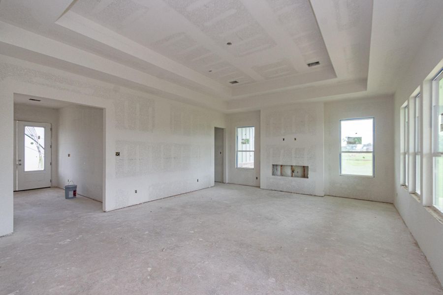 Spacious unfinished livingroom with large windows inviting natural light, offering a blank canvas for customization and creativity. Spacious unfinished livingroom with large windows inviting natural light, offering a blank canvas for customization and creativity.