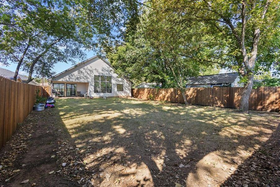 Fenced backyard featuring a patio