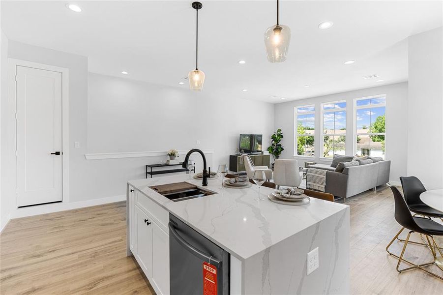 The kitchen's open design overlooking the living room establishes a perfect stage for entertaining.