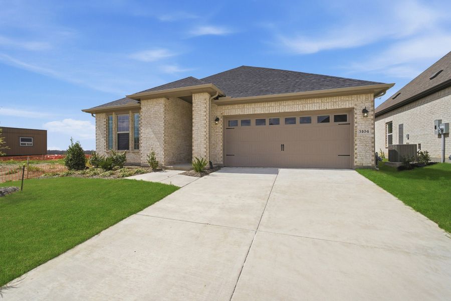 Front exterior of a new home in Westridge, McKinney, TX, highlighting curb appeal (Image 26). Front exterior of a new home in Westridge, McKinney, TX, highlighting curb appeal (Image 26).