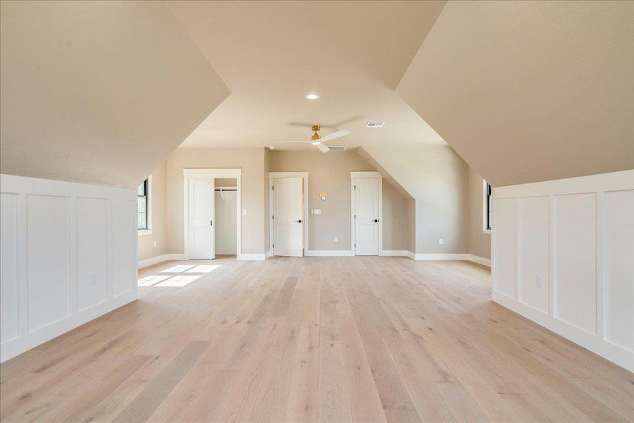 A spacious and inviting attic room offers abundant natural light and versatile living space.